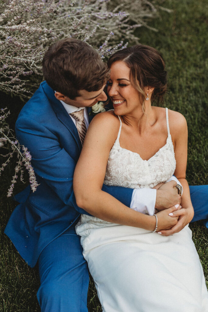 Christine and Michael smiling lovingly at each other in a lush Pennsylvania backyard, celebrating their wedding day