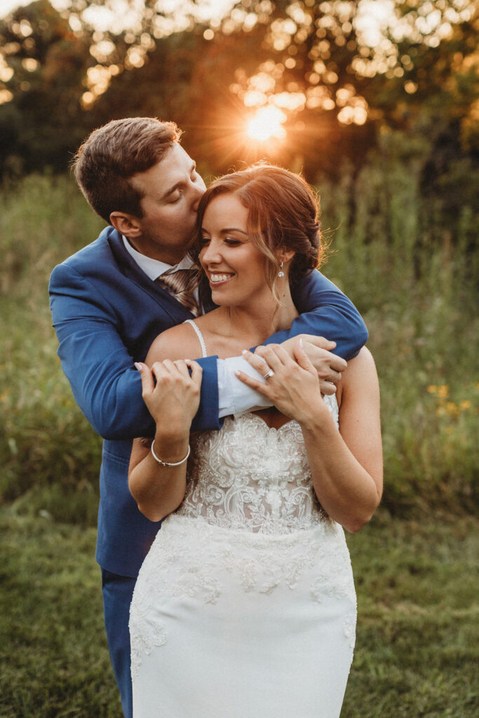 Christine and Michael smiling lovingly at each other in a lush Pennsylvania backyard, celebrating their wedding day