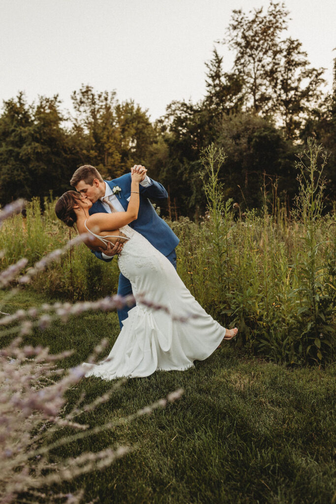 Christine and Michael smiling lovingly at each other in a lush Pennsylvania backyard, celebrating their wedding day