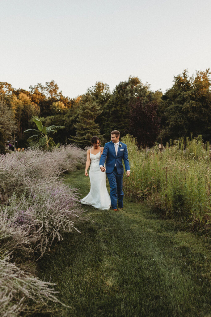 Newlyweds sharing a tender moment amidst the natural beauty of their backyard wedding in Pennsylvania