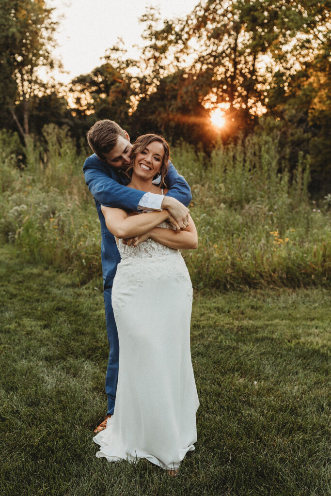 Newlyweds sharing a tender moment amidst the natural beauty of their backyard wedding in Pennsylvania