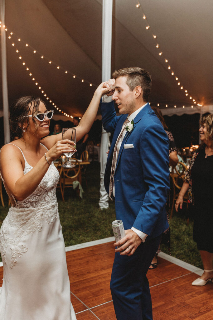 Bride and groom dancing, laughing and having fun during their backyard wedding reception in Pennsylvania