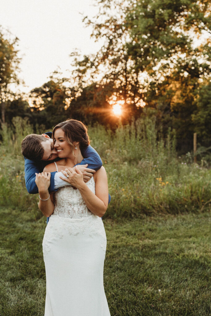 Christine and Michael smiling lovingly at each other in a lush Pennsylvania backyard, celebrating their wedding day