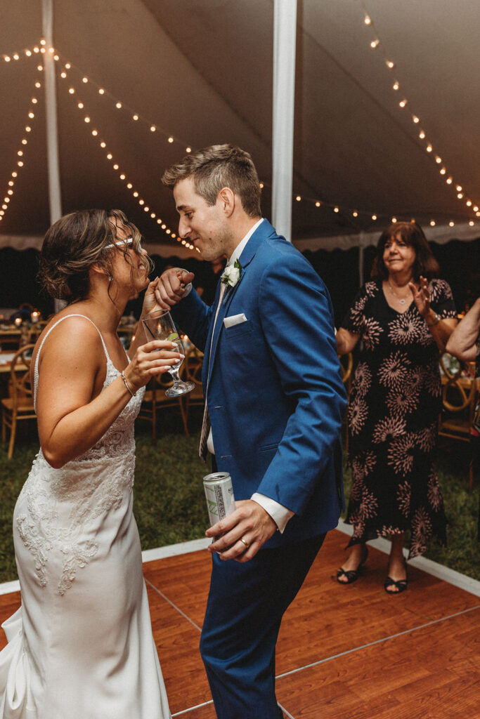 Bride and groom dancing, laughing and having fun during their backyard wedding reception in Pennsylvania