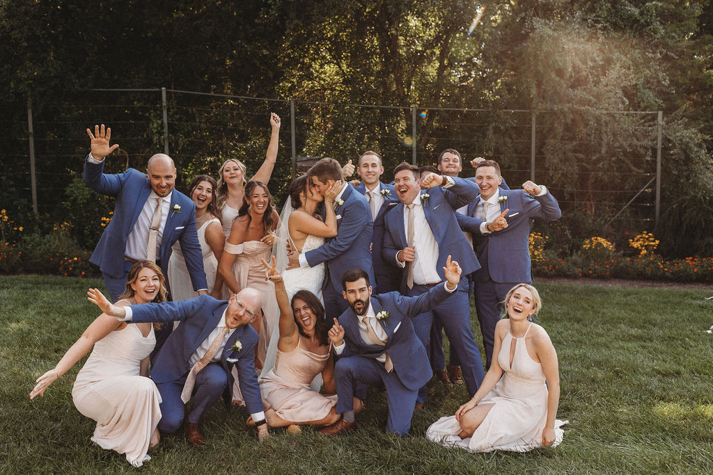 The couple and their wedding party captured in a spontaneous, joy-filled moment, radiating happiness at the backyard wedding in Pennsylvania