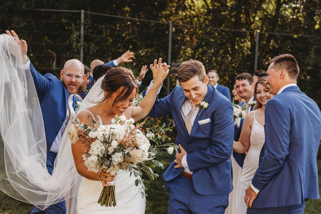 The couple and their wedding party captured in a spontaneous, joy-filled moment, radiating happiness at the backyard wedding in Pennsylvania