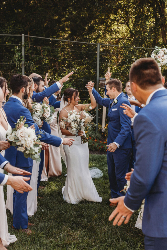 The couple and their wedding party captured in a spontaneous, joy-filled moment, radiating happiness at the backyard wedding in Pennsylvania