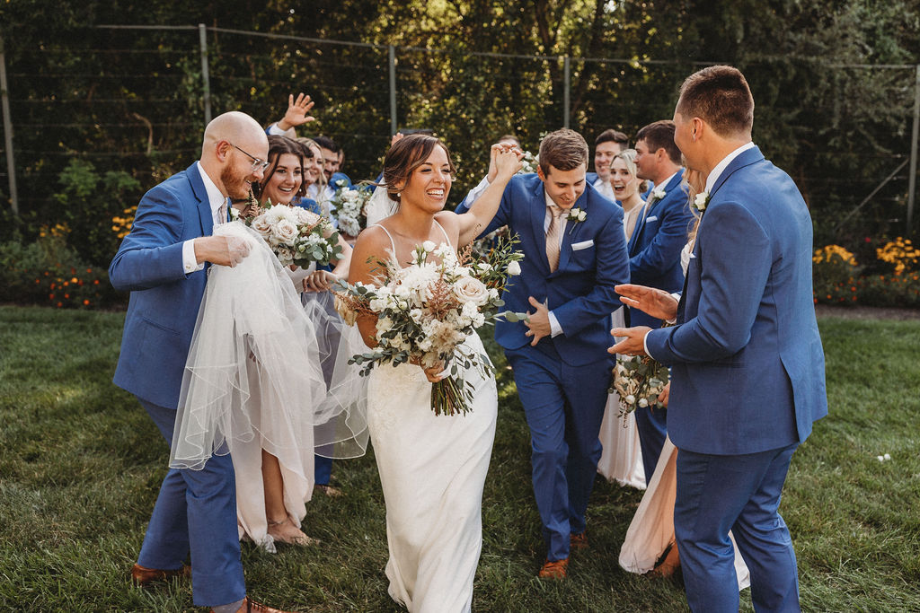 The couple and their wedding party captured in a spontaneous, joy-filled moment, radiating happiness at the backyard wedding in Pennsylvania