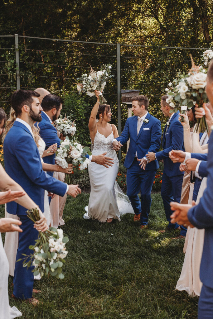 The couple and their wedding party captured in a spontaneous, joy-filled moment, radiating happiness at the backyard wedding in Pennsylvania