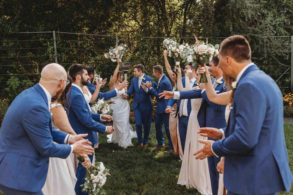 The couple and their wedding party captured in a spontaneous, joy-filled moment, radiating happiness at the backyard wedding in Pennsylvania