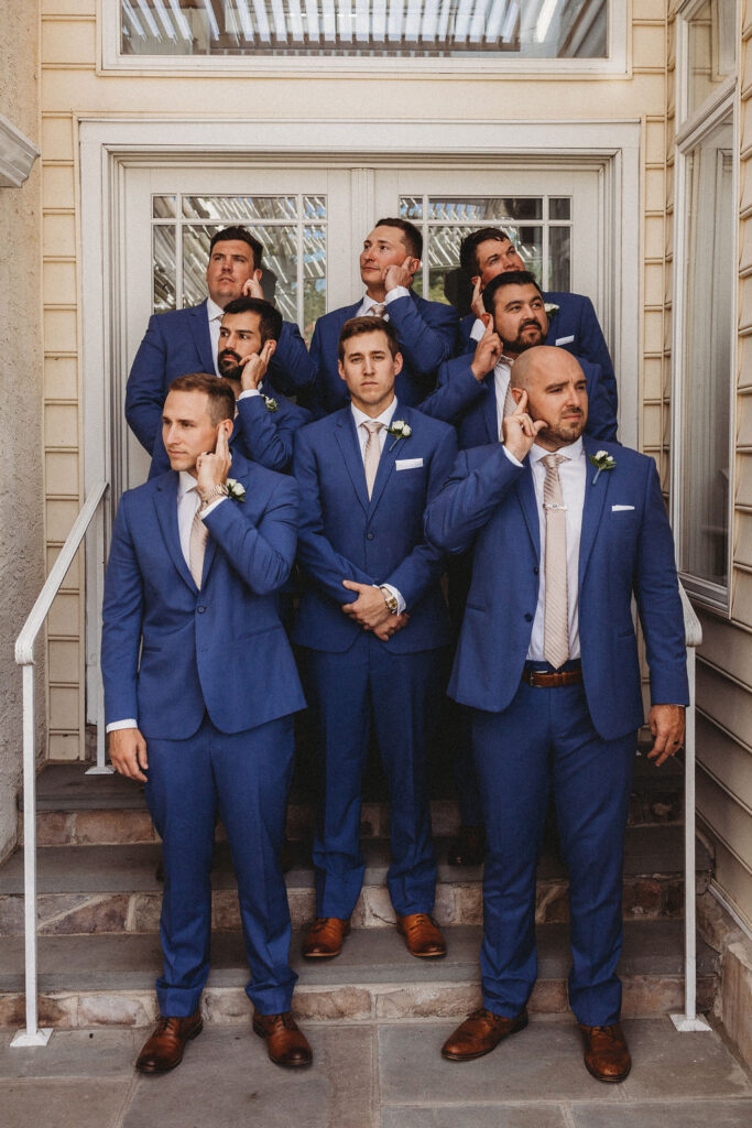 Michael and his groomsmen striking playful poses in the Pennsylvania backyard, adding a touch of humor to the wedding festivities