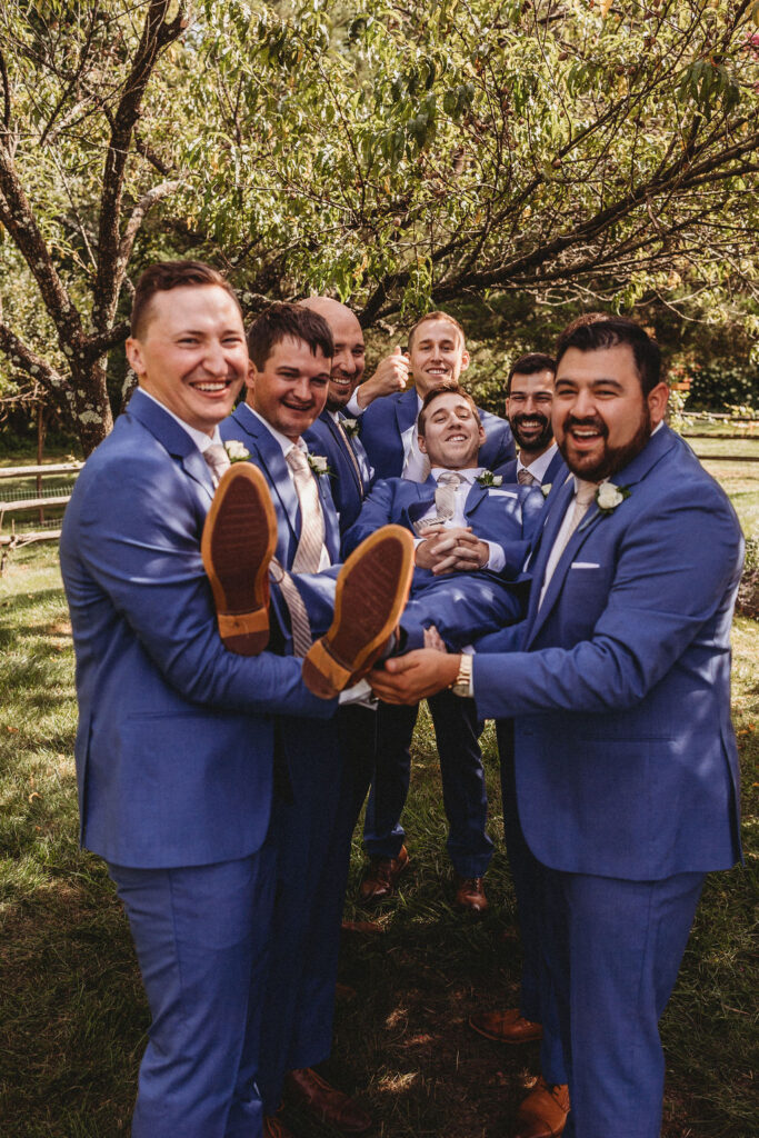 Michael and his groomsmen striking playful poses in the Pennsylvania backyard, adding a touch of humor to the wedding festivities