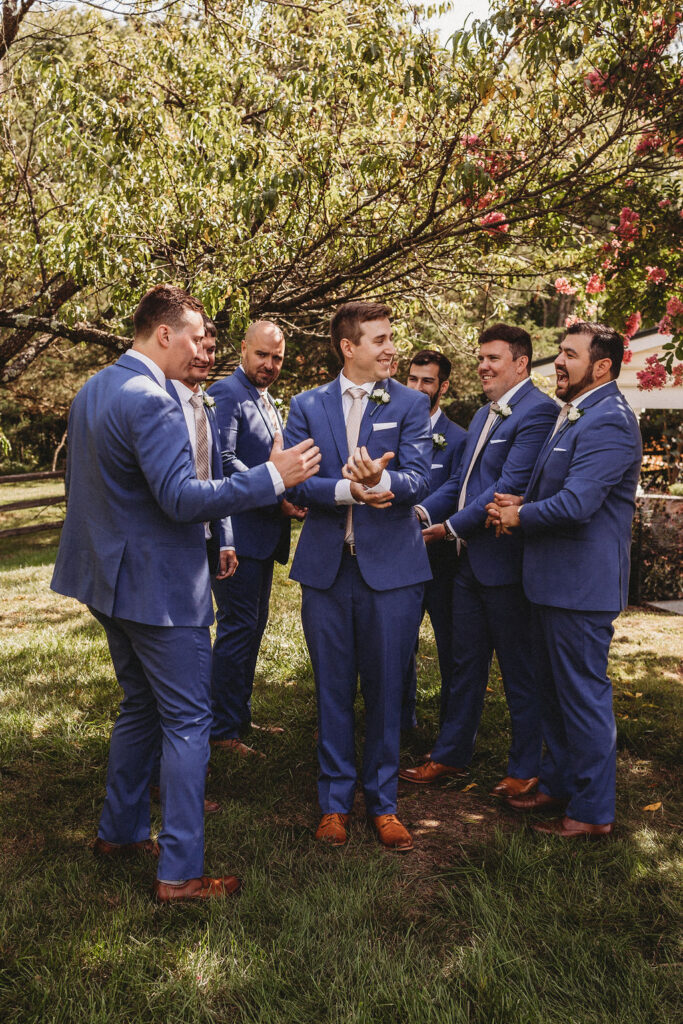 Michael and his groomsmen striking playful poses in the Pennsylvania backyard, adding a touch of humor to the wedding festivities