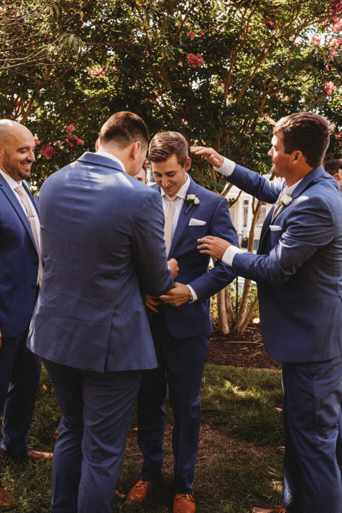 Michael and his groomsmen striking playful poses in the Pennsylvania backyard, adding a touch of humor to the wedding festivities