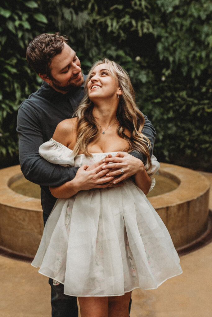 romantic couple cuddling during their longwood gardens engagement session