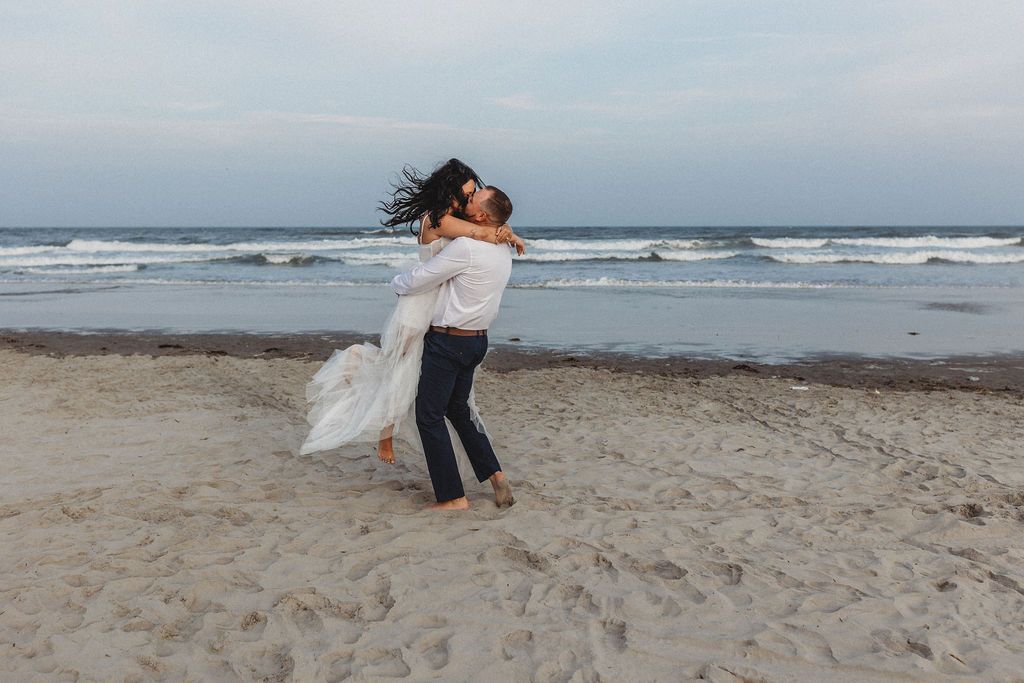 romantic bride and groom kiss at the beach during their hawaii elopement