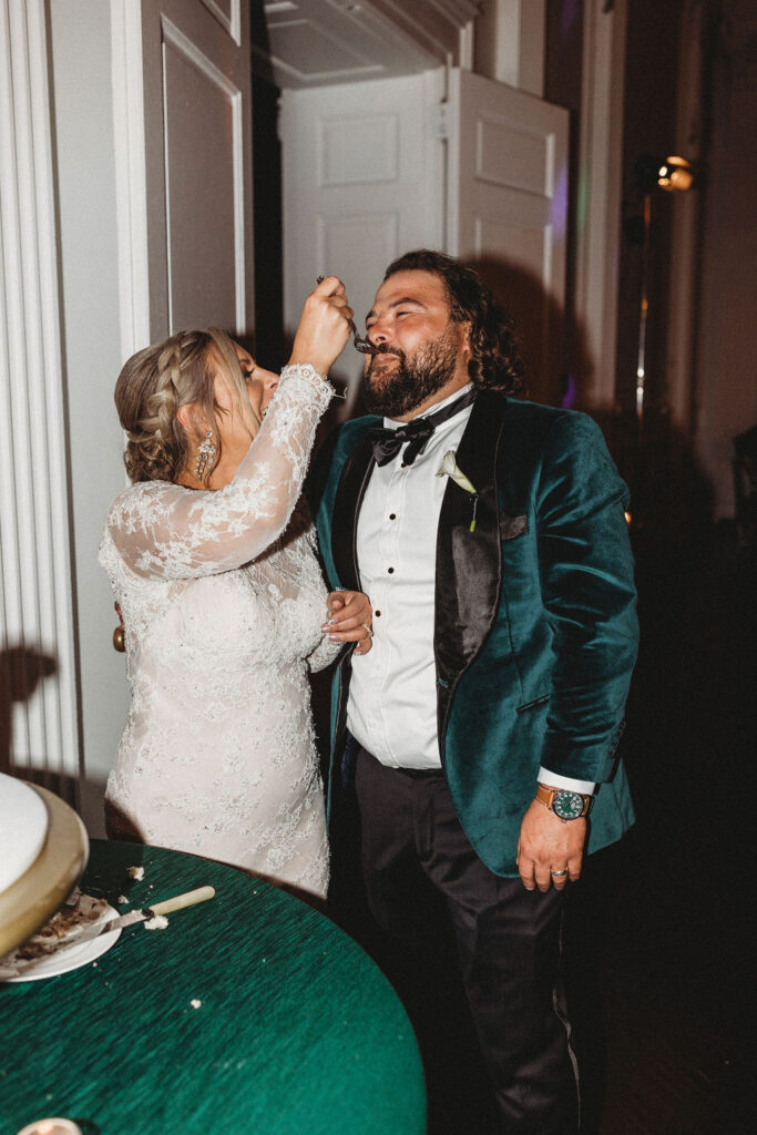 bride and groom cutting cake