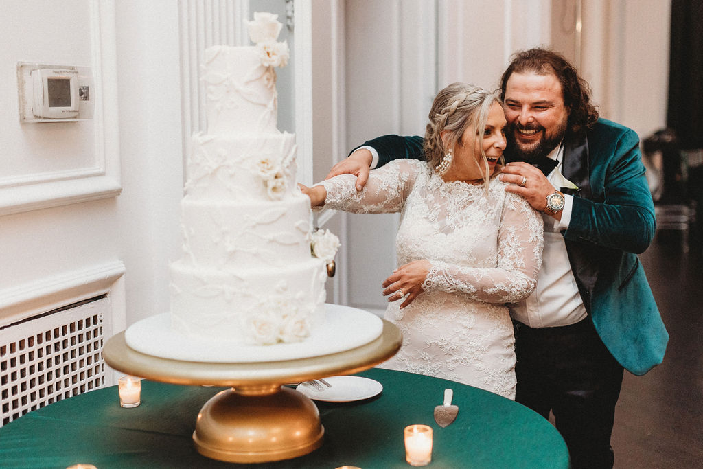 bride and groom cutting cake