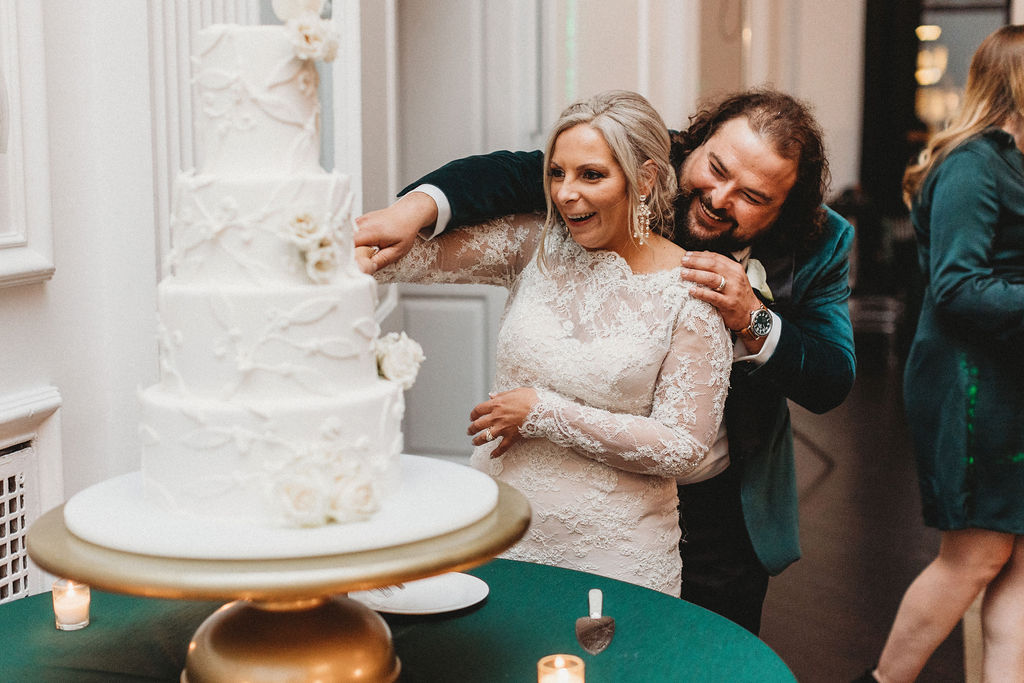 bride and groom cutting cake