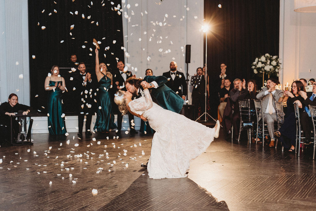 bride and groom first dance, a flower petal canon sprayed petals everywhere