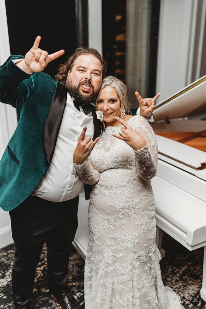 bride and groom posing by an elegant white piano at the downtown club by cescaphe