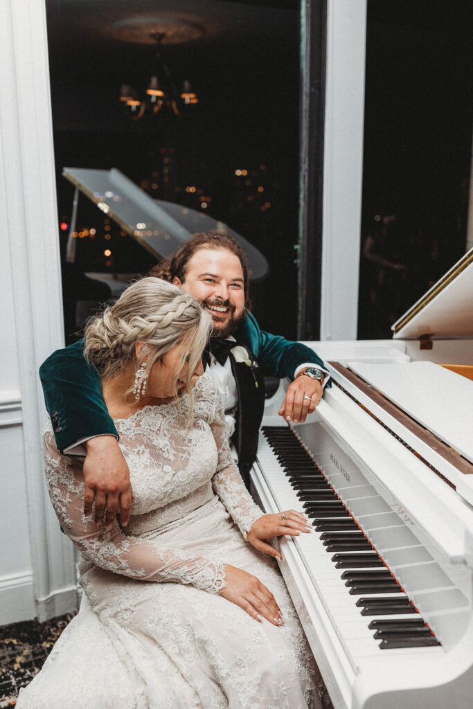 bride and groom posing by an elegant white piano at the downtown club by cescaphe