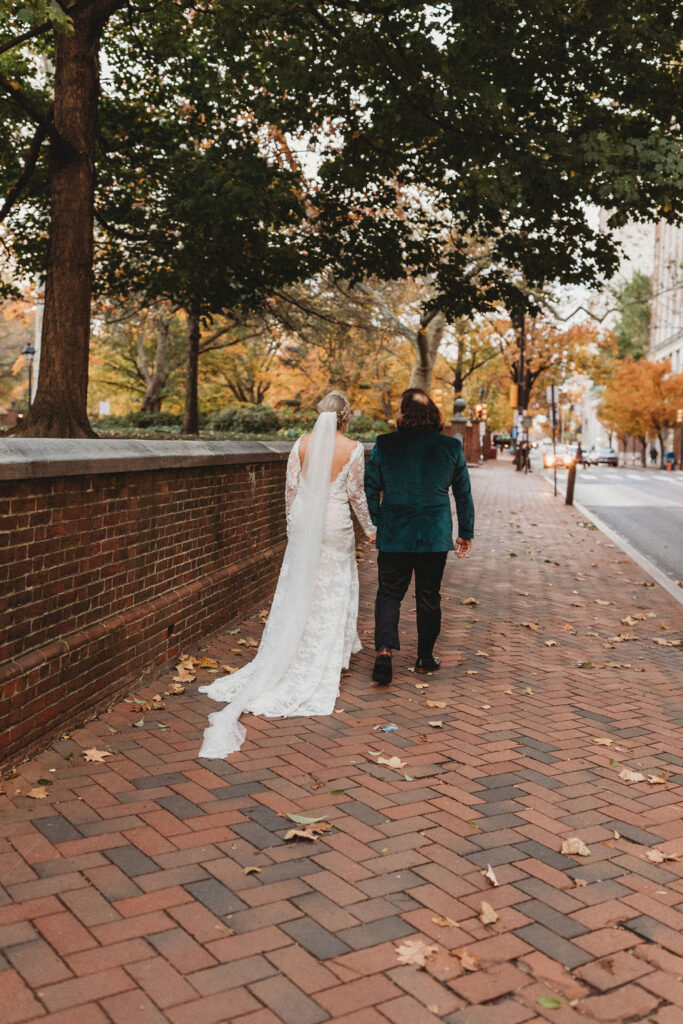 candid bride and groom walking around and snapping pics in downtown philadelphia