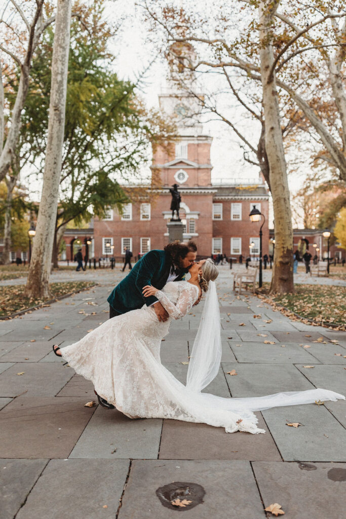 candid bride and groom walking around and snapping pics in downtown philadelphia