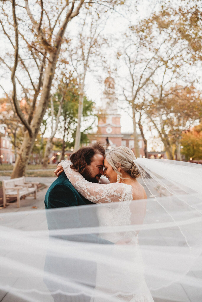 candid bride and groom walking around and snapping pics in downtown philadelphia