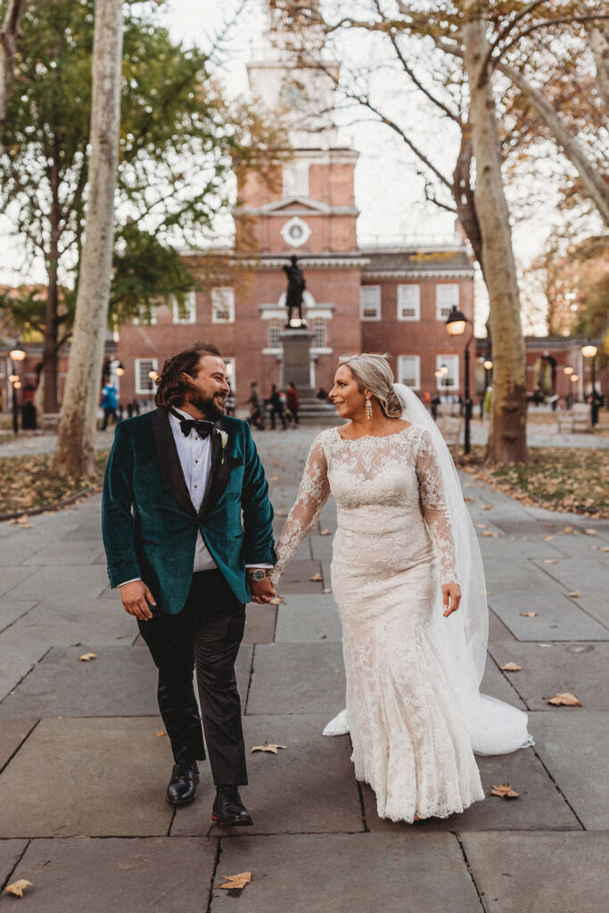 candid bride and groom walking around and snapping pics in downtown philadelphia