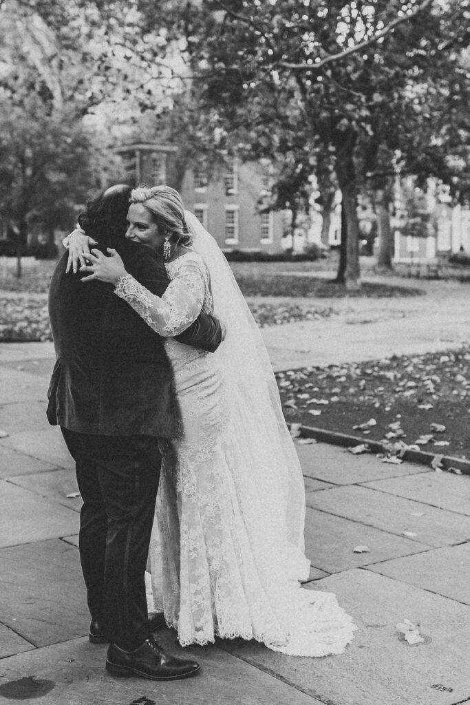 candid bride and groom walking around and snapping pics in downtown philadelphia