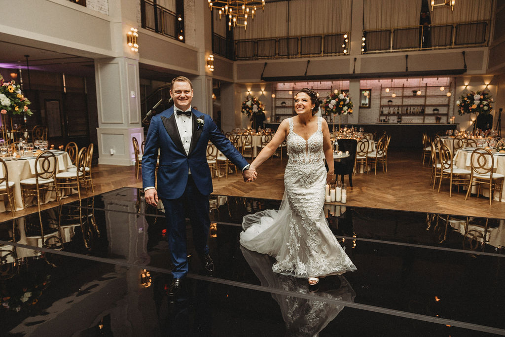 bride and groom entering the reception at the lucy by cescaphe