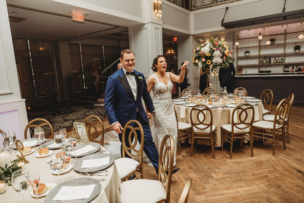 bride and groom entering the reception at the lucy by cescaphe