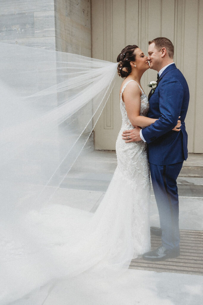 bride and groom posing at the Merchants exchange building in philadelphia