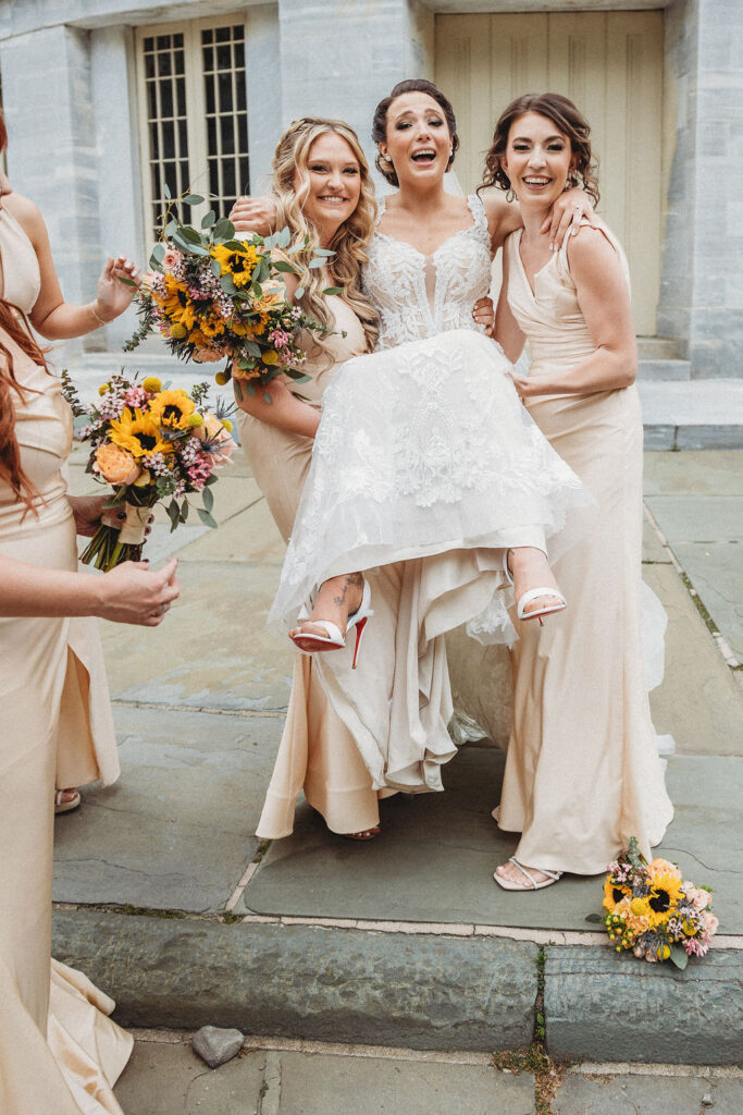 bride and bridesmaids in neutral bridesmaid dresses at the merchants exchange building in philadelphia