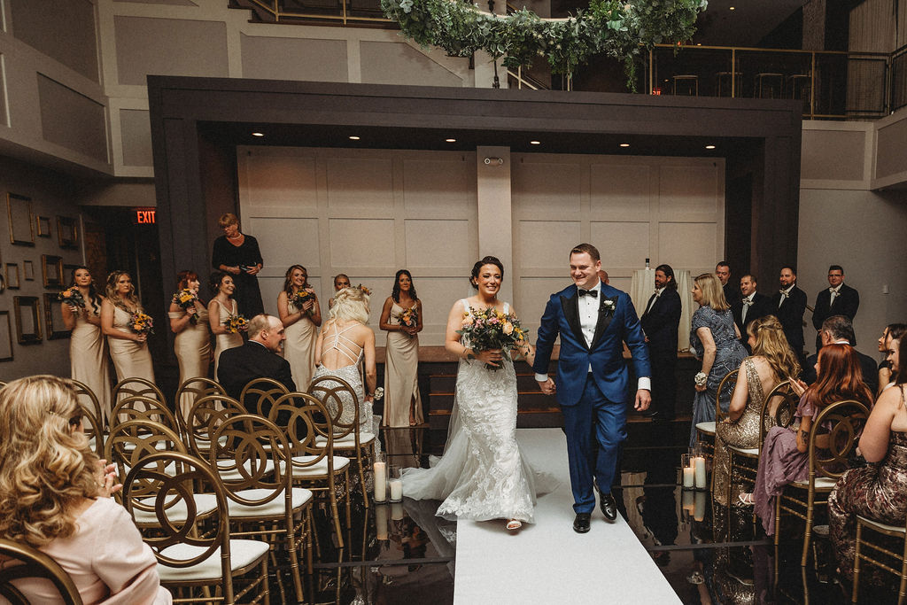 bride and groom leaving the ceremony at the lucy by cescaphe