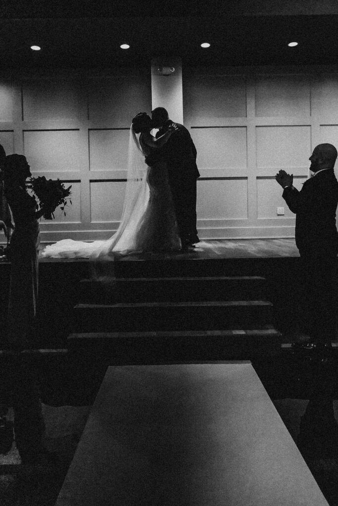 bride and groom first kiss