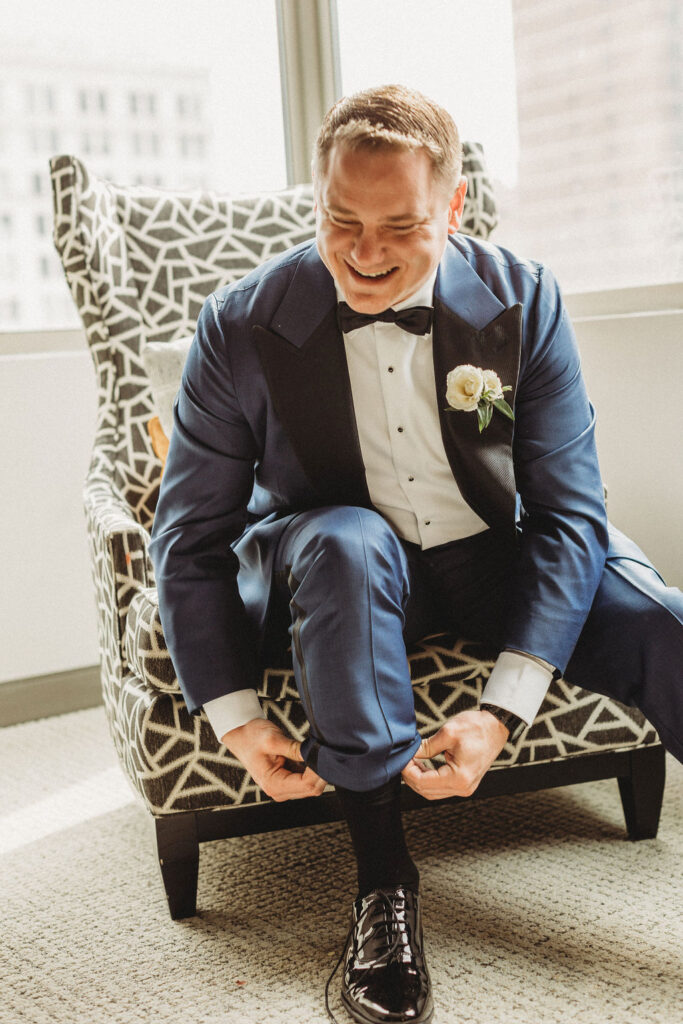 groom getting ready in a hotel room