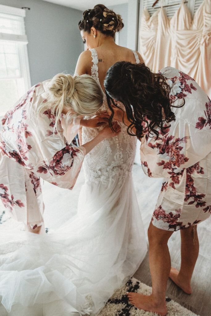 bridesmaids helping the bride get ready in a hotel room