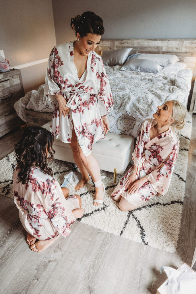 bridesmaids helping the bride get ready in a hotel room